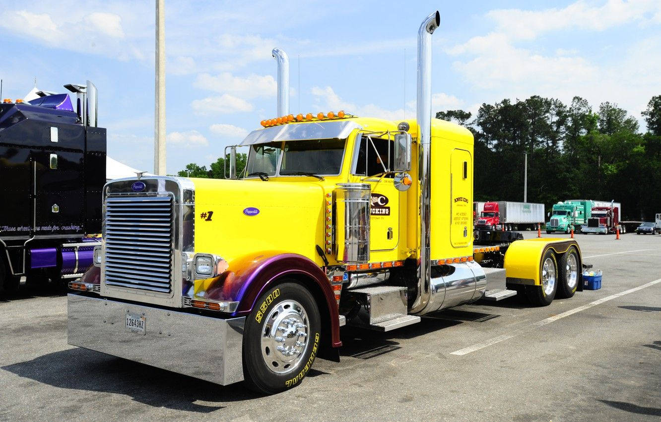 Powerful Yellow Cool Truck Cruising On The Open Road Wallpaper