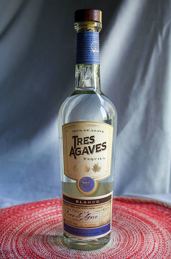 Premium Blanco Tres Agaves Tequila Against A White Cloth Backdrop Wallpaper