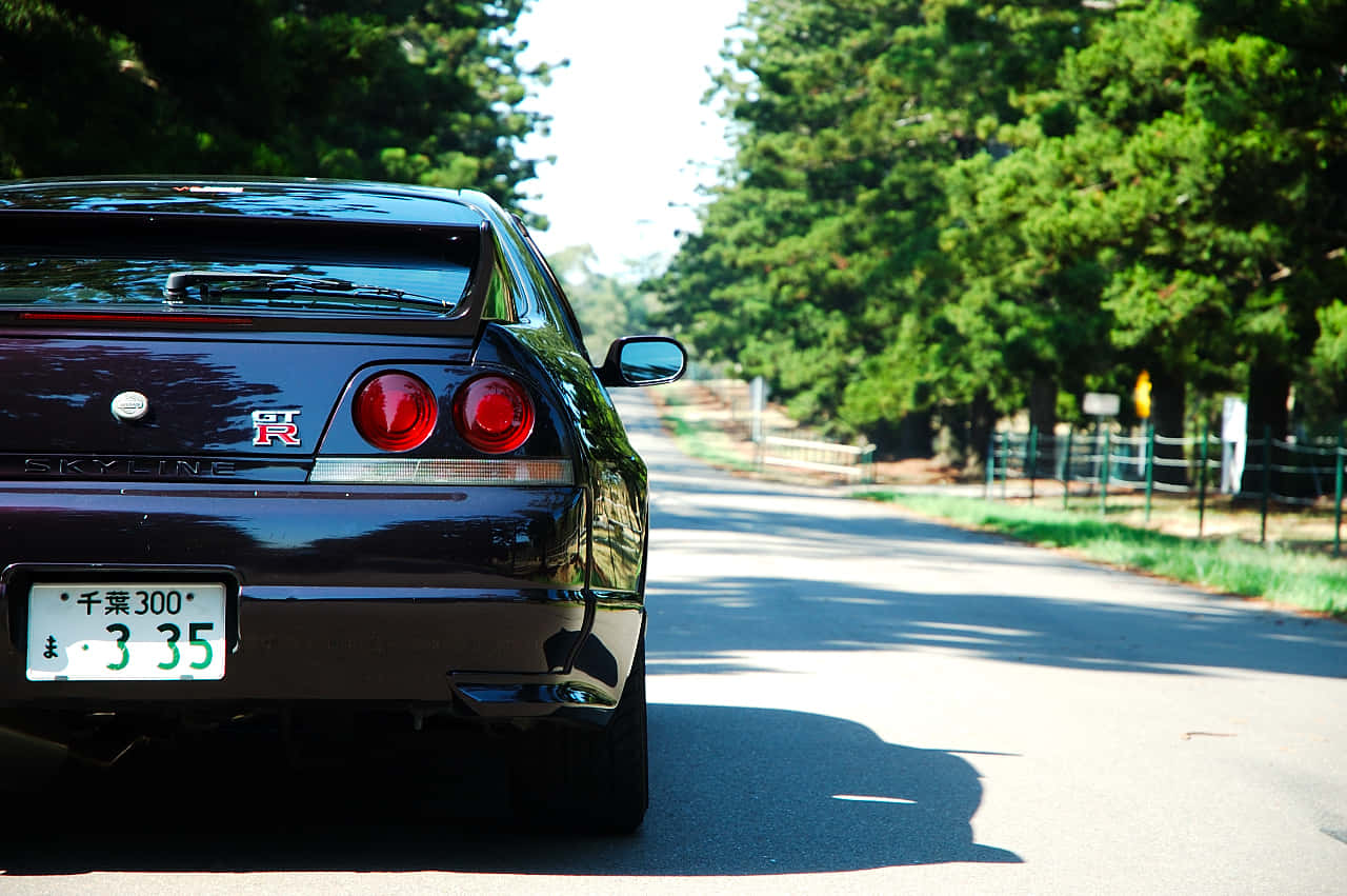 R33 Gtr Maroon Driving Wallpaper