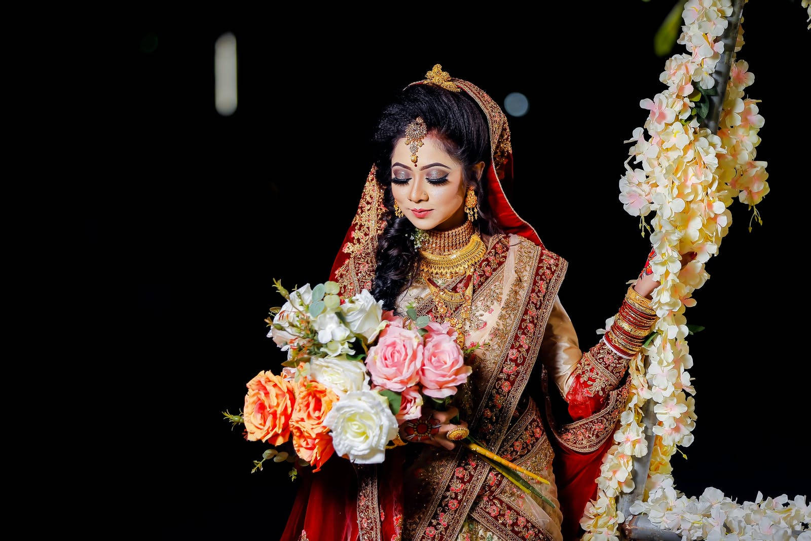 Radiant Indian Bride Holding A Bouquet At Her Wedding Wallpaper