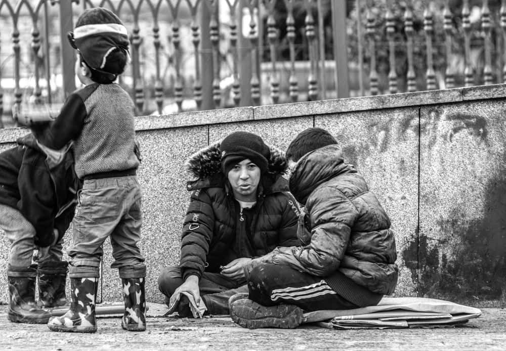 Random People Sitting On Sidewalk Wallpaper