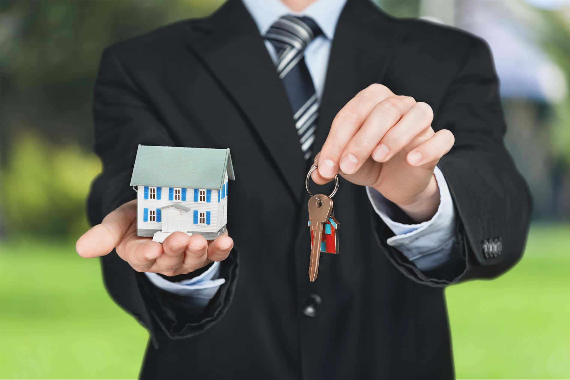 Real Estate Agent Holding Houseand Keys Wallpaper