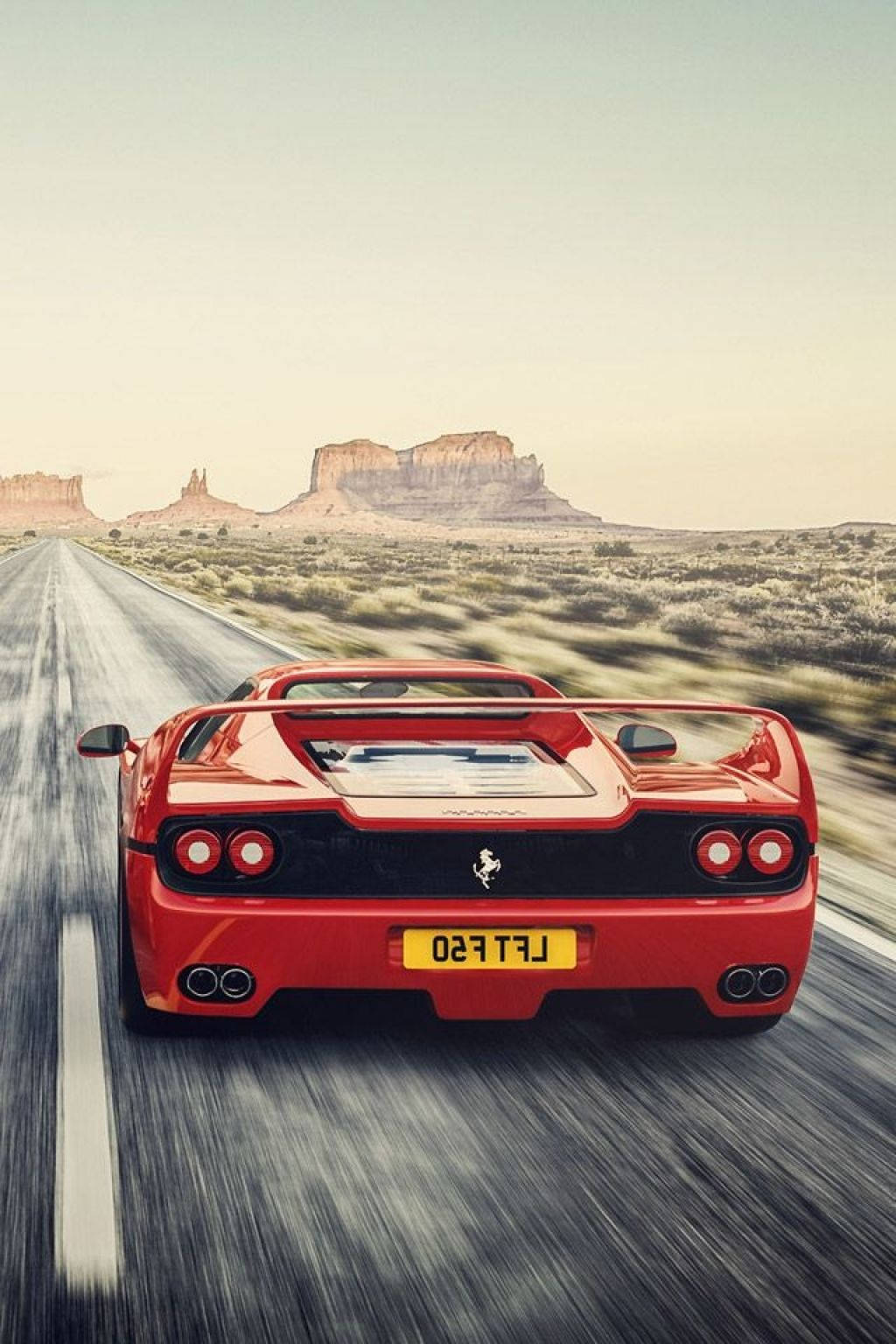 Red F50 Ferrari Phone On Dessert Road Wallpaper