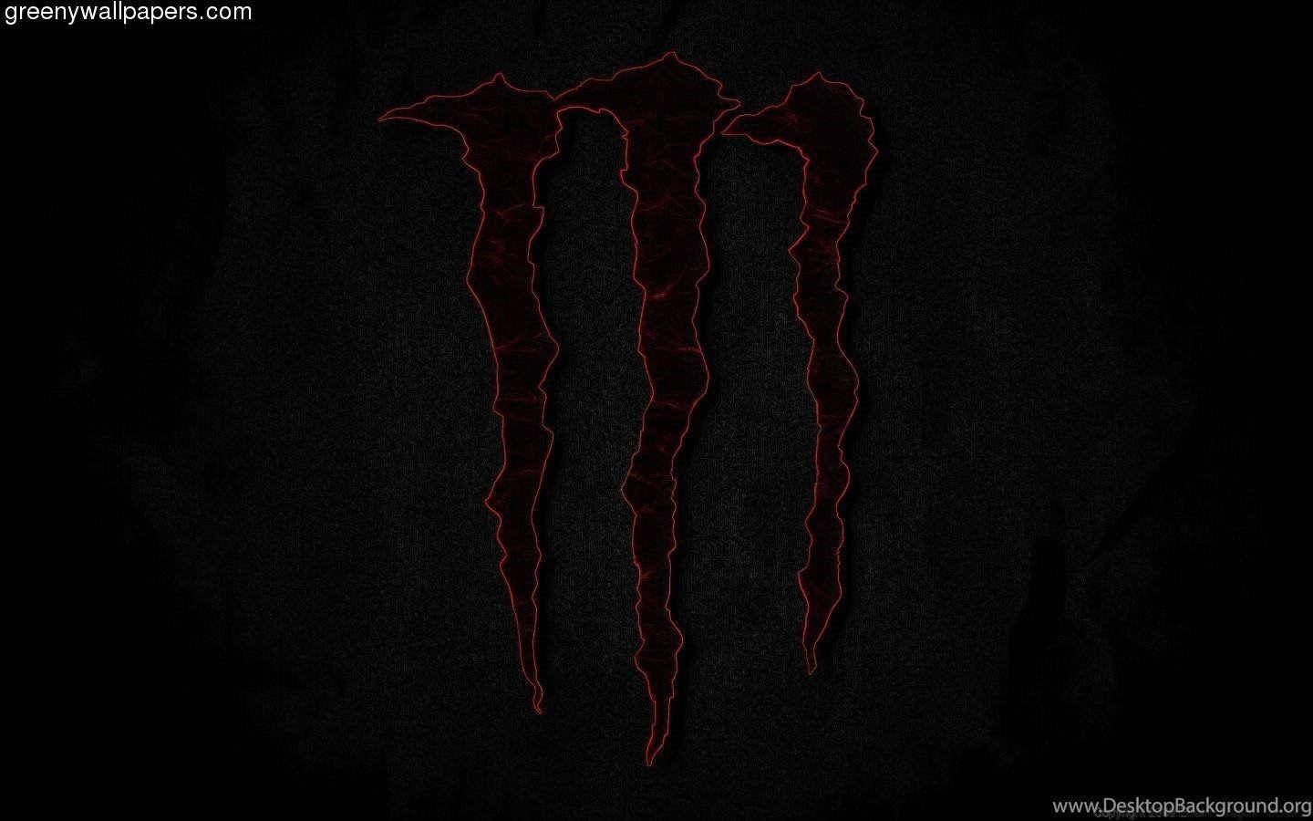 Red Monster Logo Illuminated On Dark Screen Wallpaper
