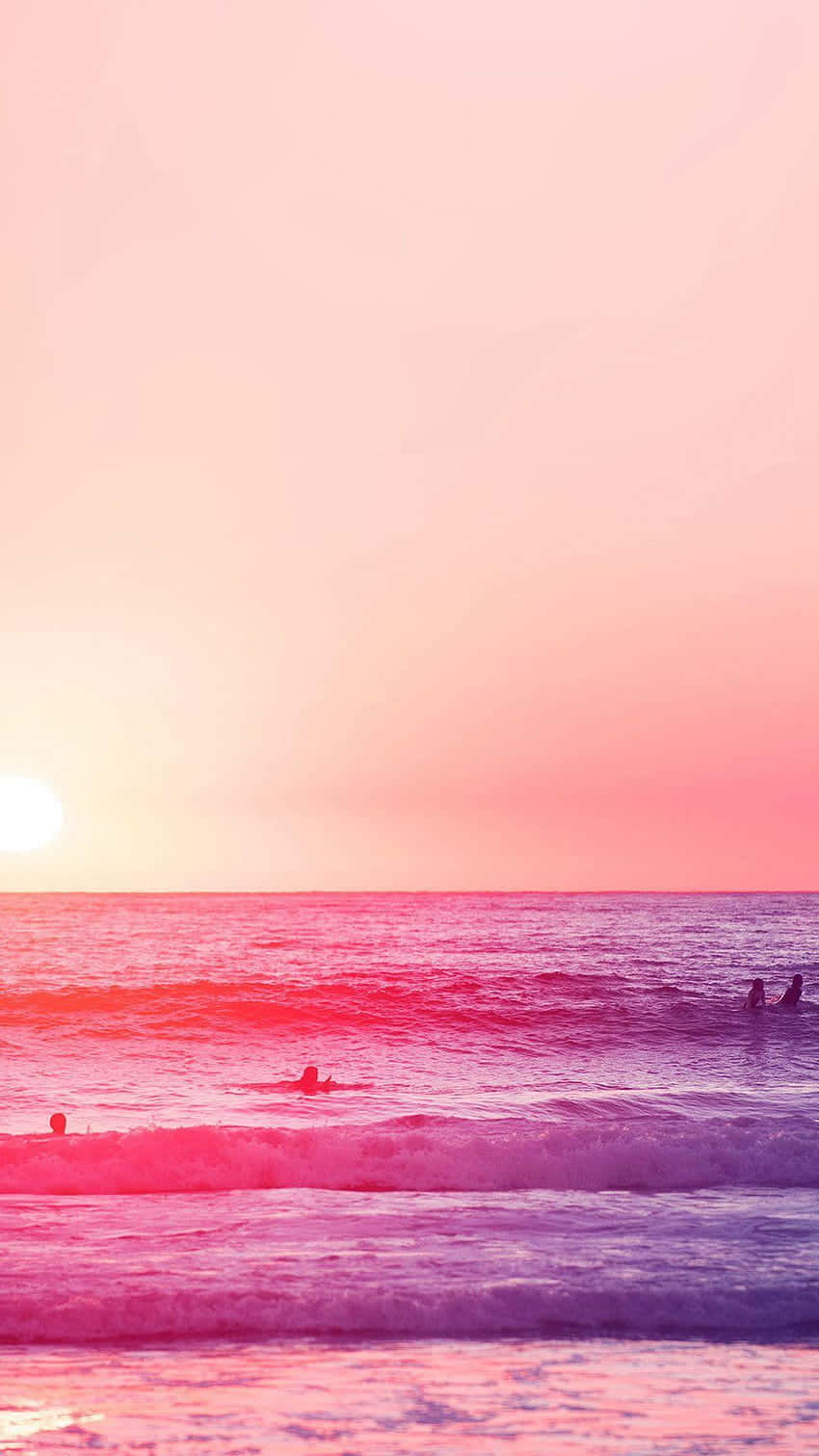 Relaxing At A Pink-hued Beach Wallpaper