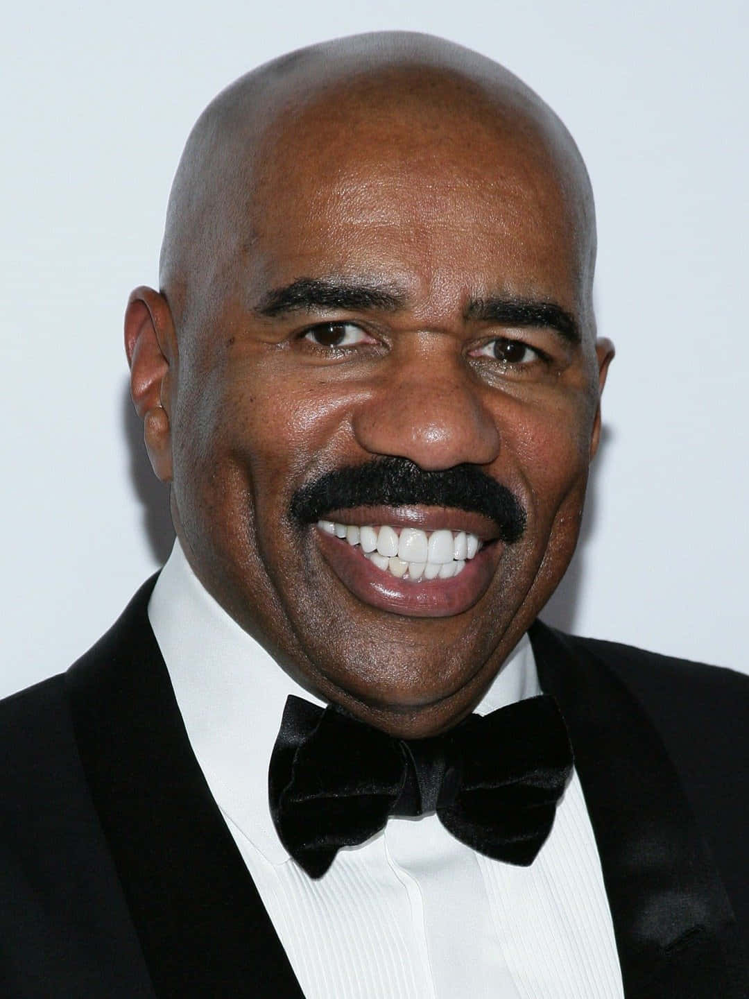 Renowned Television Personality, Steve Harvey, Captured In A Joyous Moment Wallpaper