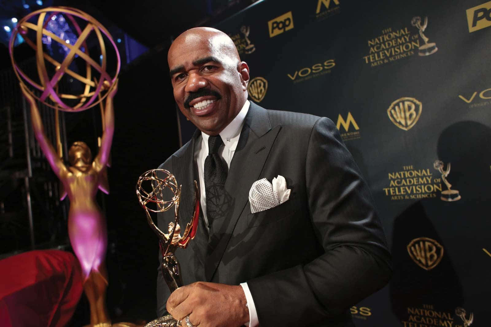 Renowned Tv Personality, Steve Harvey, Proudly Holding His Achievement Award Wallpaper