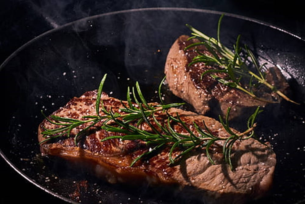 Rosemary Cooking Meat On Pan Wallpaper