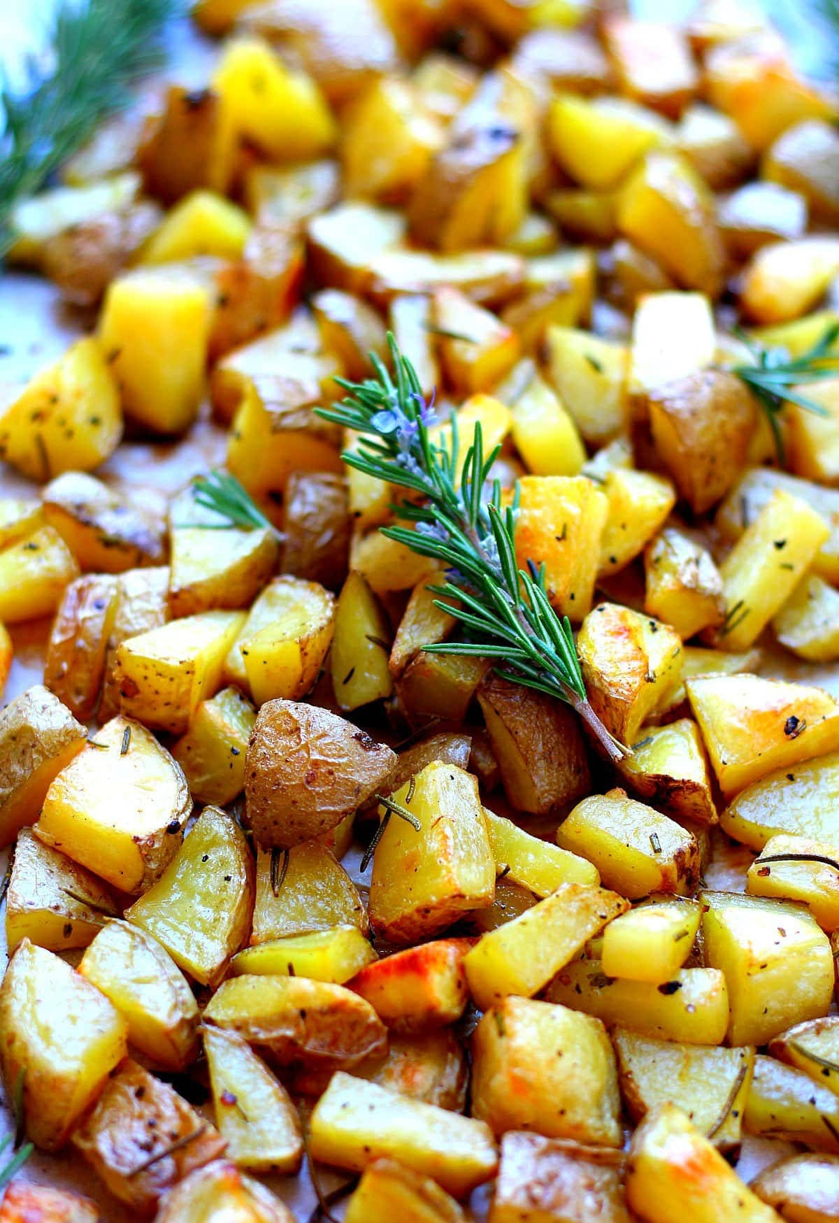 Rosemary Herb Sprinkled On Golden Baked Potato Wedges Wallpaper