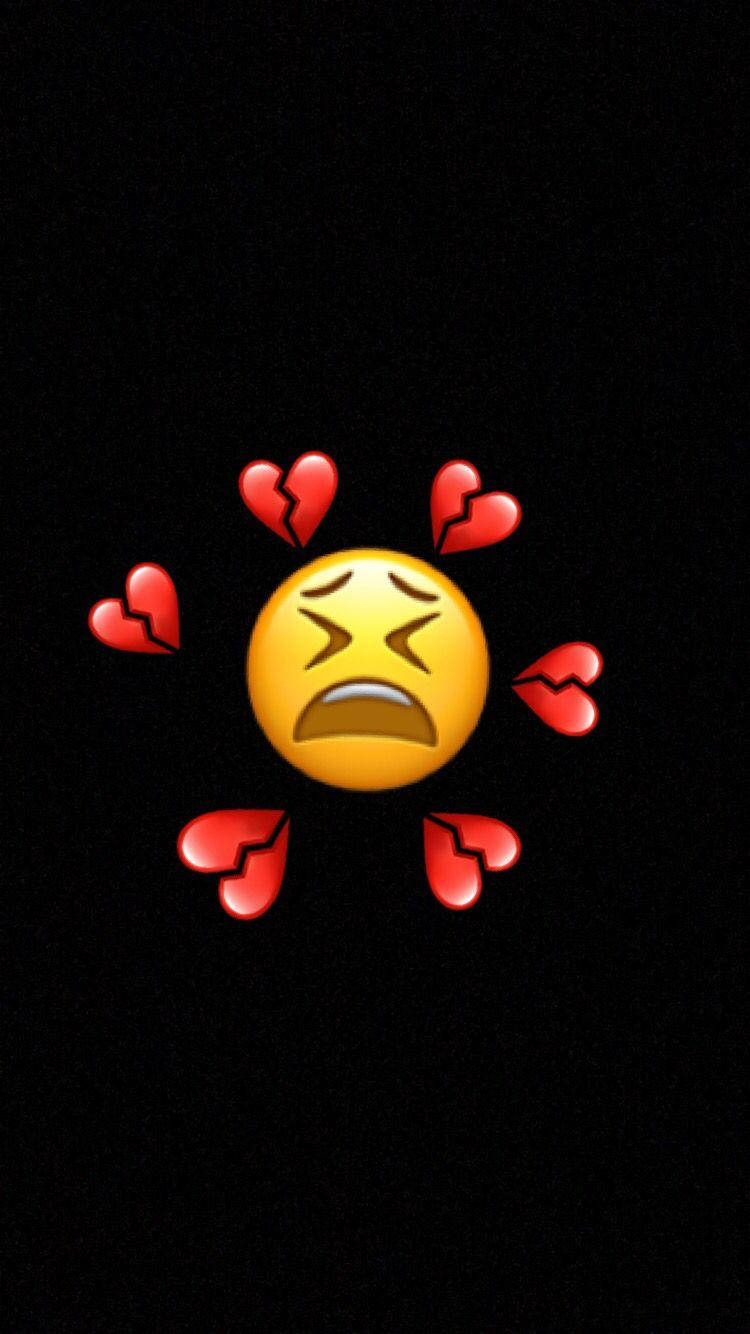 Sad Emoji Amidst Broken Heart Iphone Wallpaper