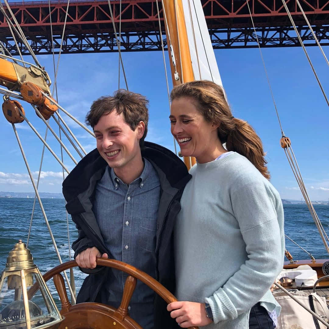 Sailing Smiles Under Bridge Wallpaper