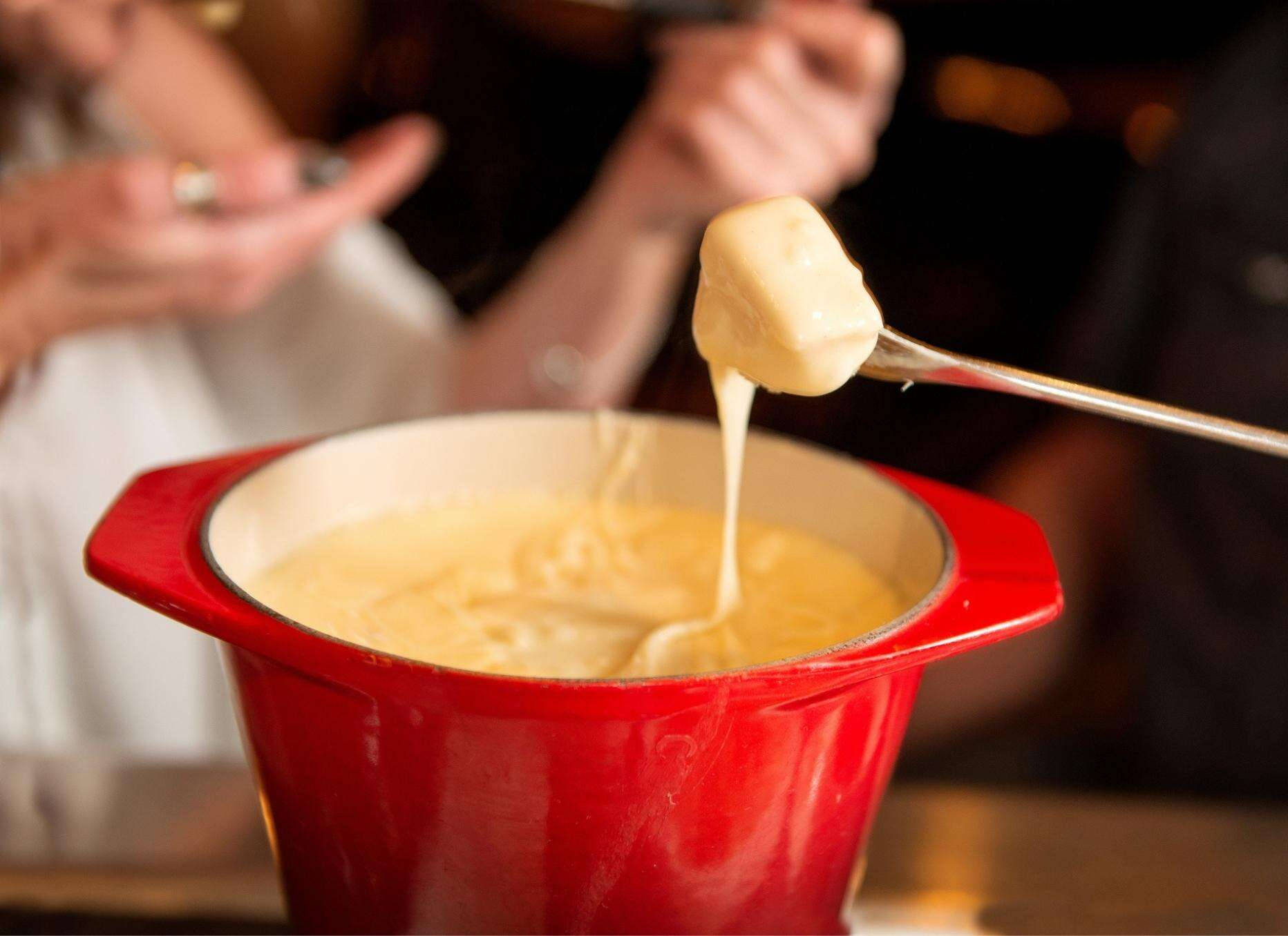 Scrumptious Cheese Fondue In A Red Pot Wallpaper