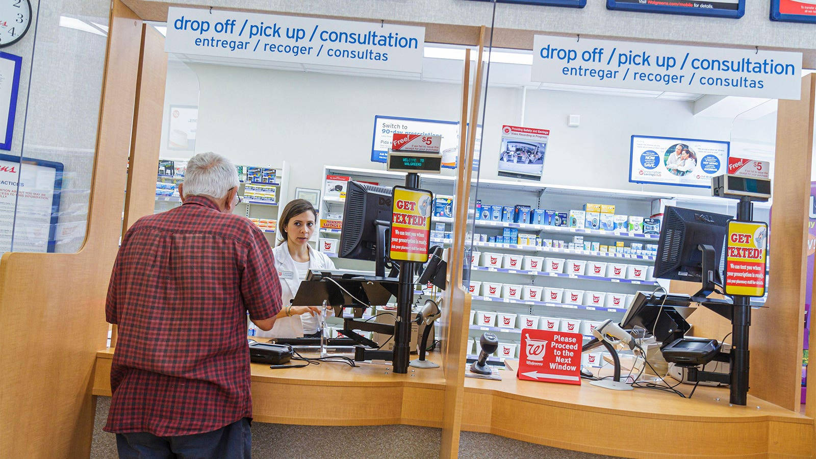 Senior Man Making Purchase At Pharmacy Wallpaper