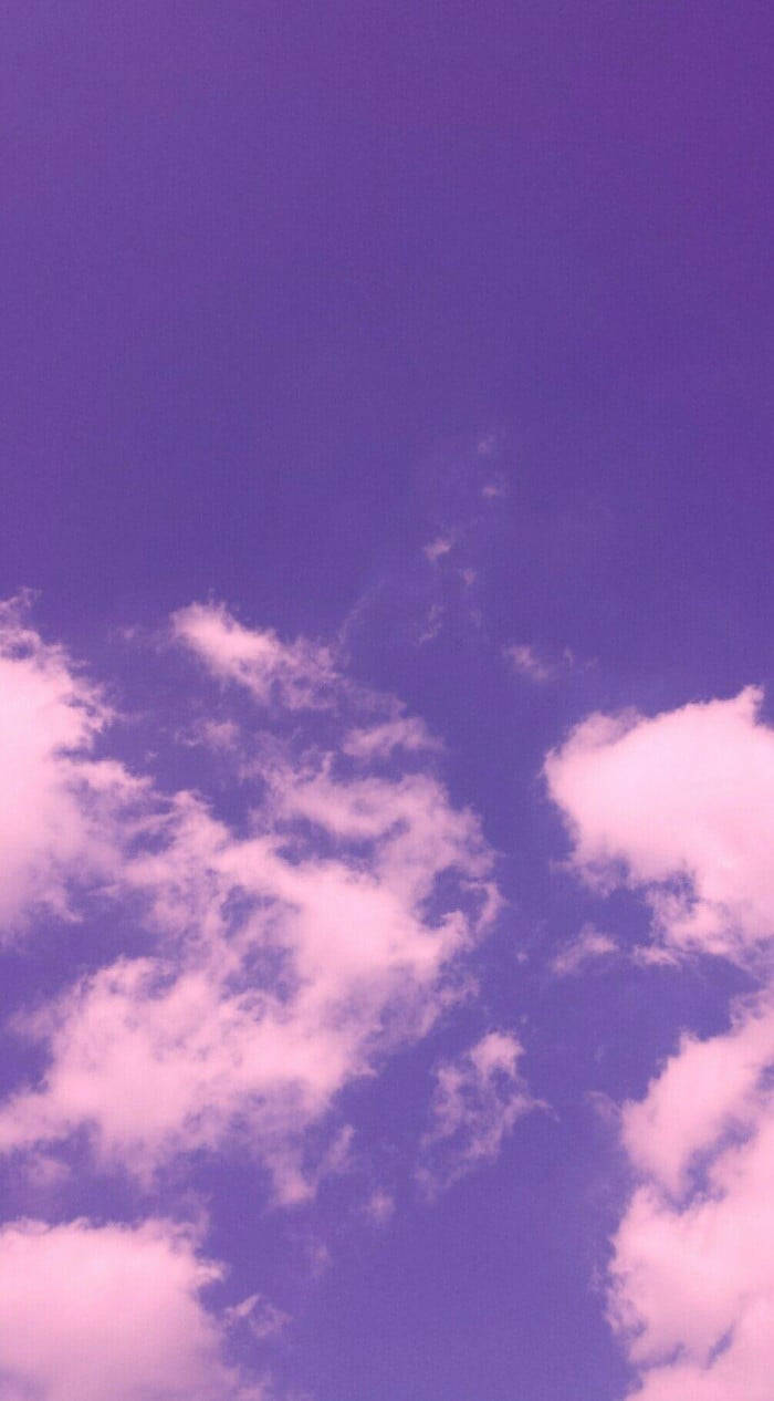 Serene Purple Clouds In A Vast Blue Sky Wallpaper