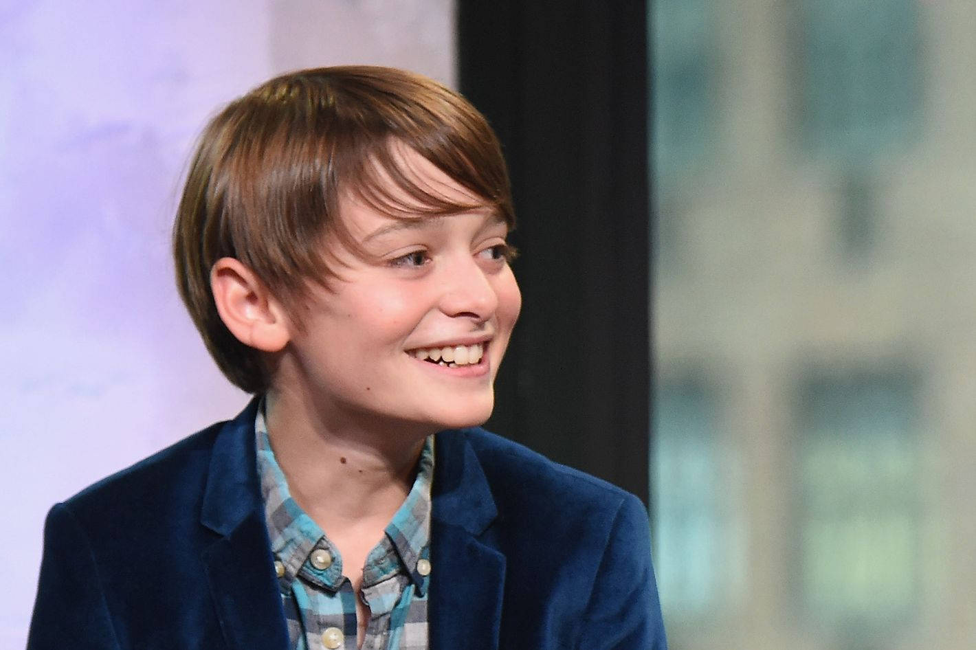 Side View Of Young Noah Schnapp Wallpaper