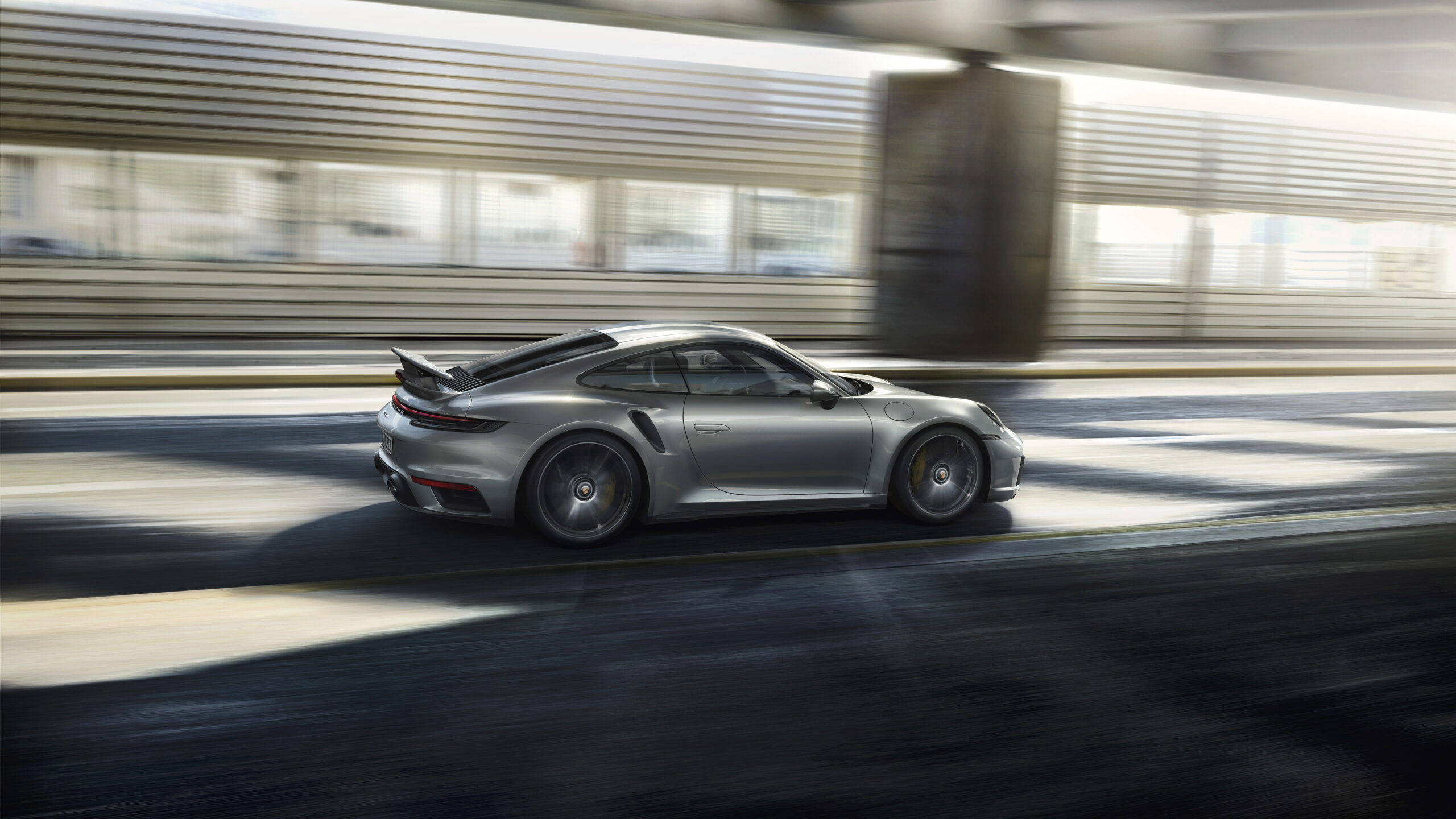 Silver Porsche 911 Driving Beside Building Wallpaper