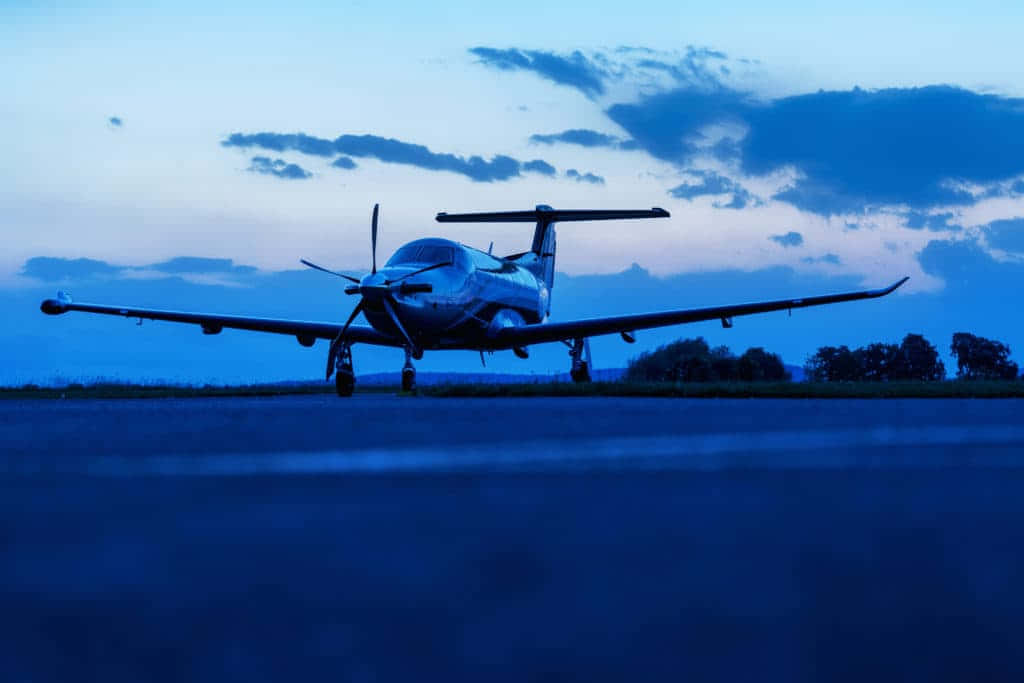 Small Airplane On Runway At Dim Afternoon Wallpaper