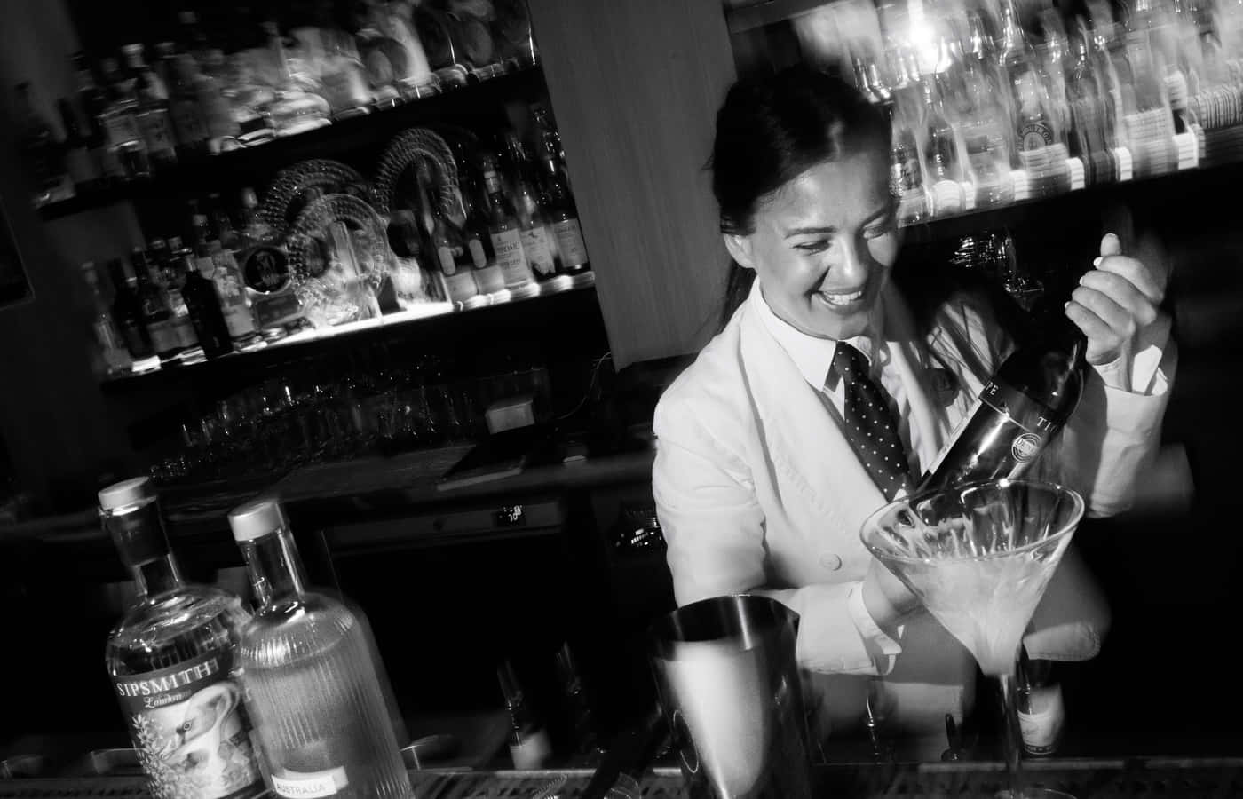 Smiling Bartender Pouring Cocktail Wallpaper