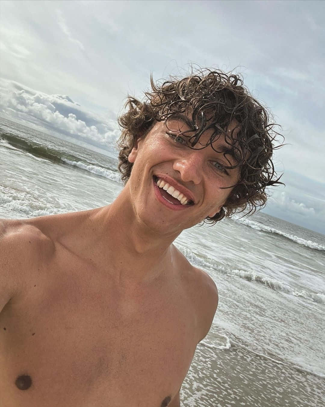 Smiling Young Man Beach Selfie Wallpaper