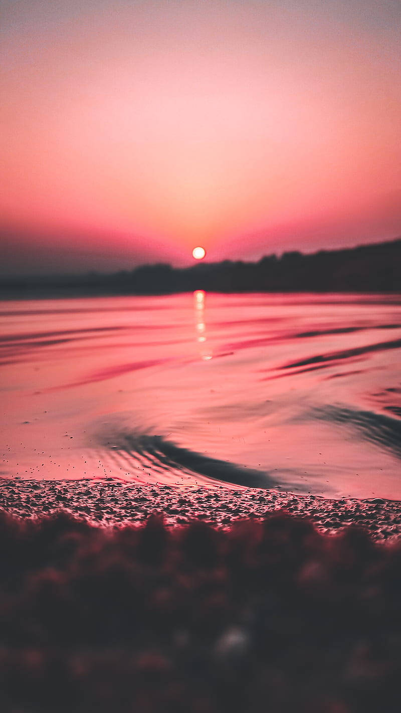 Soak In The Beauty Of A Pink And Orange Sunset With Your Iphone Wallpaper