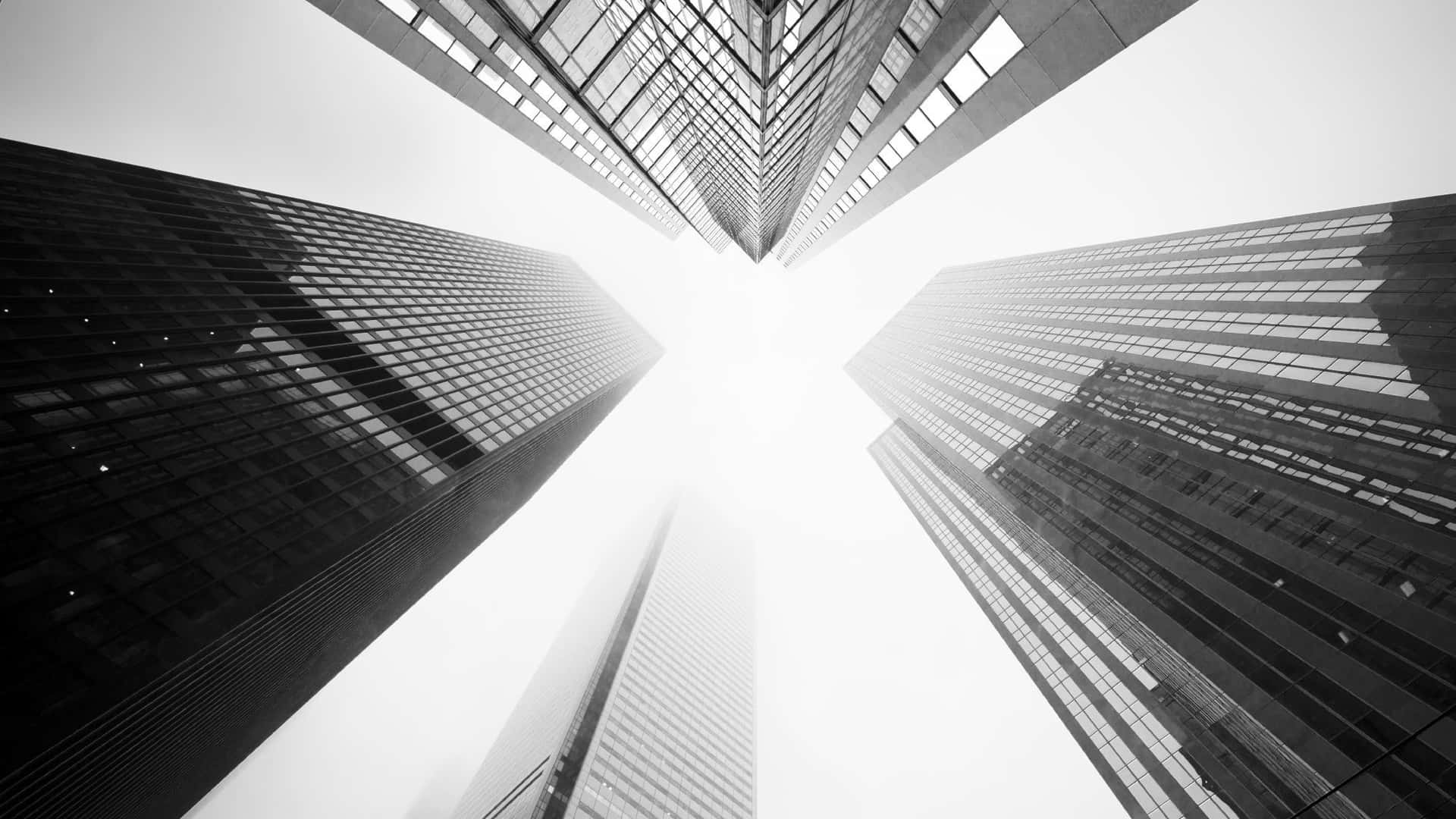 Soft White Aesthetic Sky Over Tall Skyscrapers Wallpaper