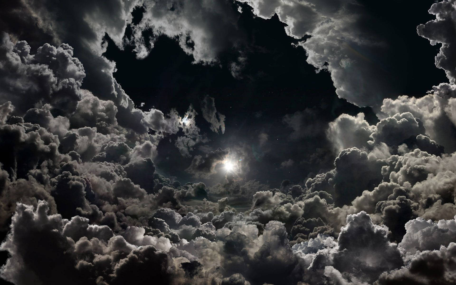 Spectacular Display Of Glowing Moon Within High-resolution Clouds Wallpaper