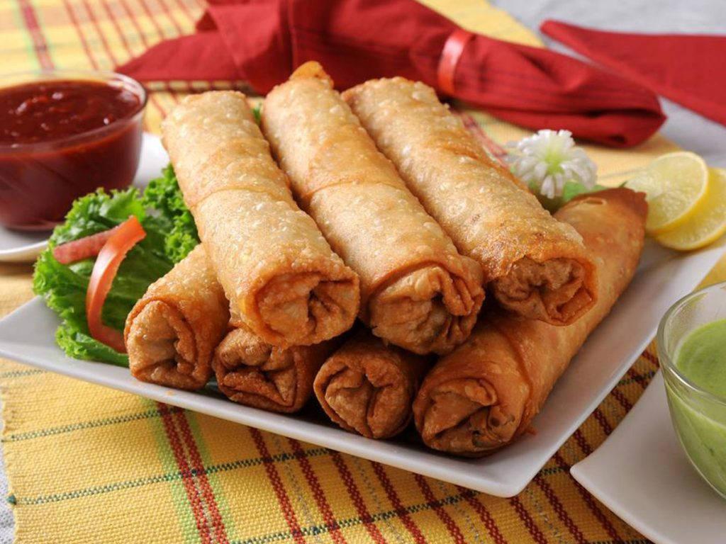 Stack Of Egg Rolls With Ketchup Dip Wallpaper