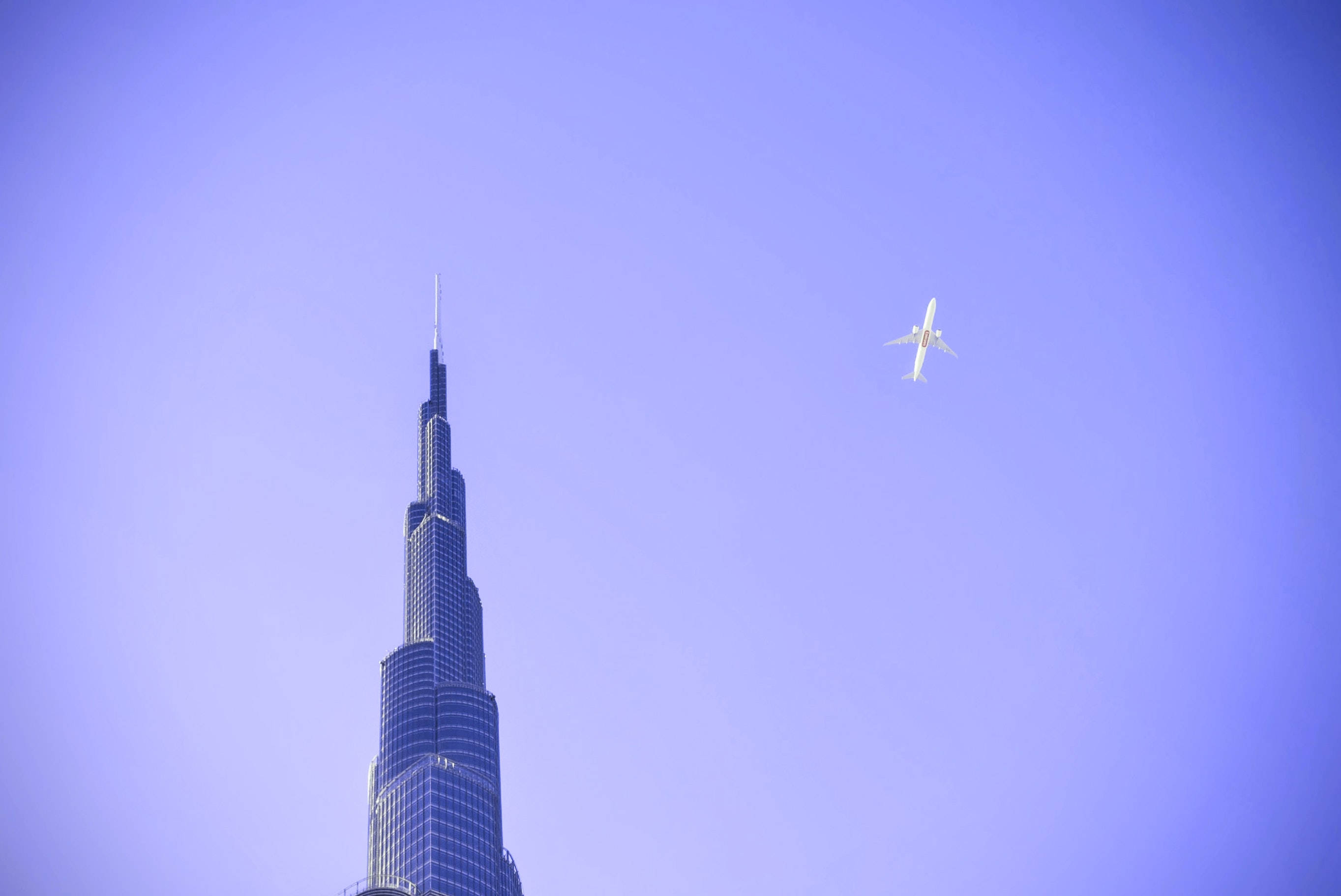 Stunning View Of Burj Khalifa With Plane In Sky Wallpaper
