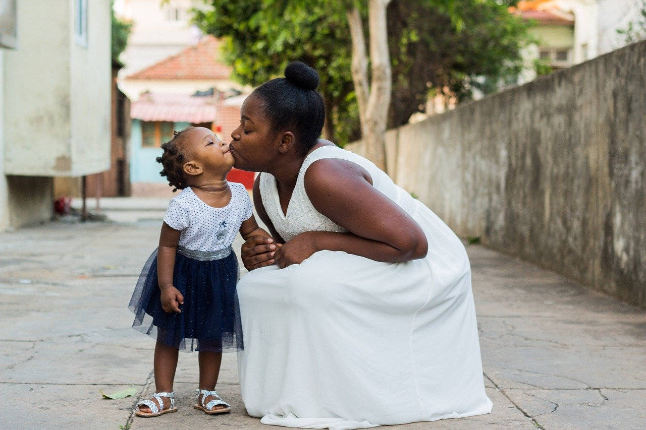 Sweetly Posed Mother And Daughter Wallpaper