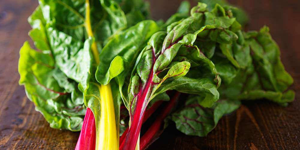 Swiss Chard Vegetables Atop Wooden Platform Wallpaper