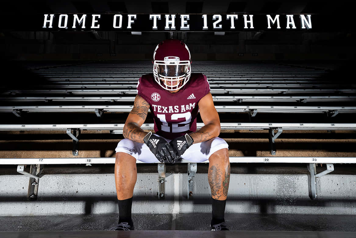 Texas Am Man In A Football Uniform Sitting On The Bleachers Wallpaper