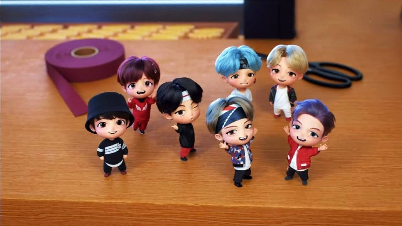 Tiny Tan Bts Action Figure In Table Wallpaper