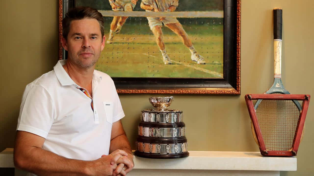 Todd Woodbridge Displaying His Trophy At Home Wallpaper