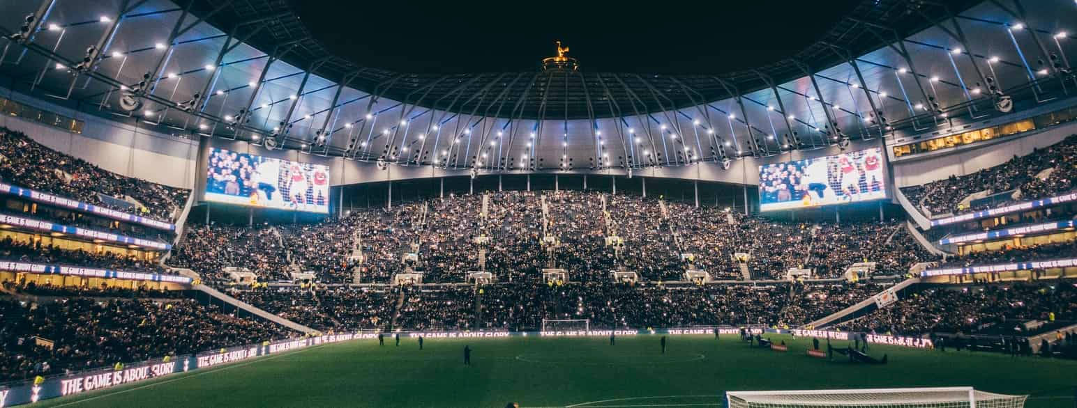 Tottenham Hotspurs Fc Stadium Interior At Night Wallpaper