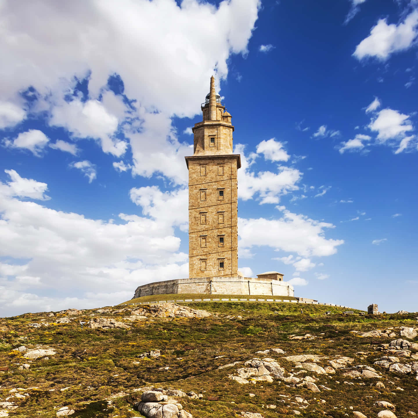 Tower Of Hercules Beneath Cloudy Blue Sky Wallpaper