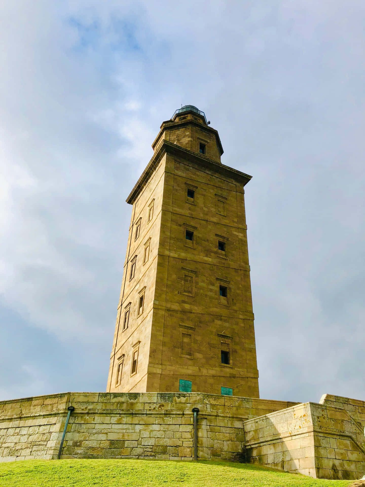 Tower Of Hercules Beneath The Cloudy Sky Wallpaper