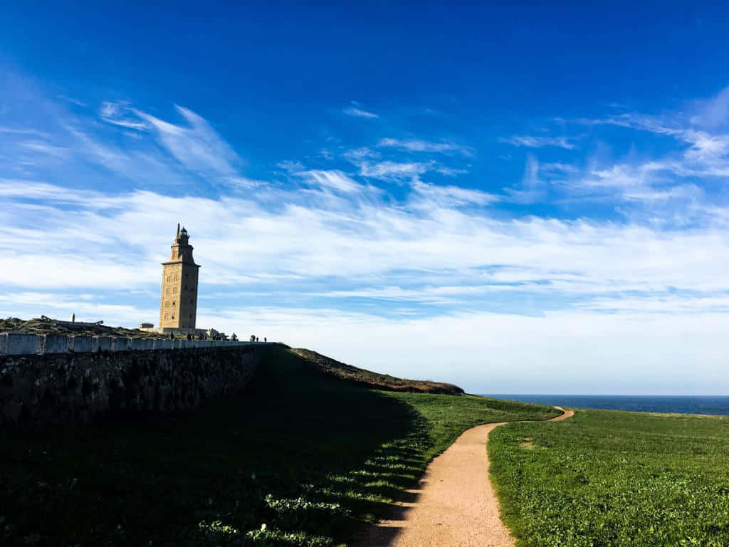 Tower Of Hercules Jutting From Grass Wallpaper