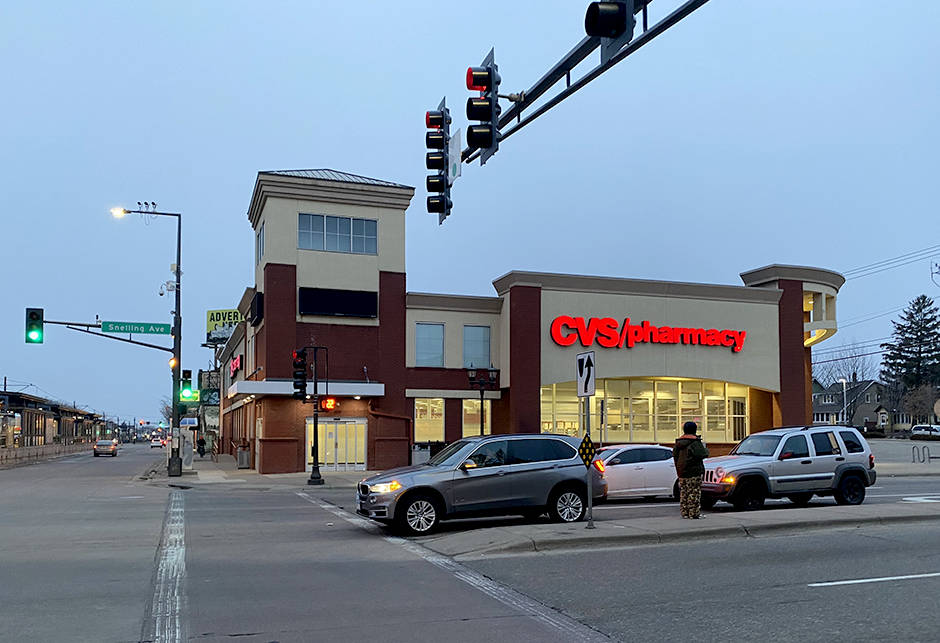 Traffic In Front Of A Cvs Pharmacy Wallpaper