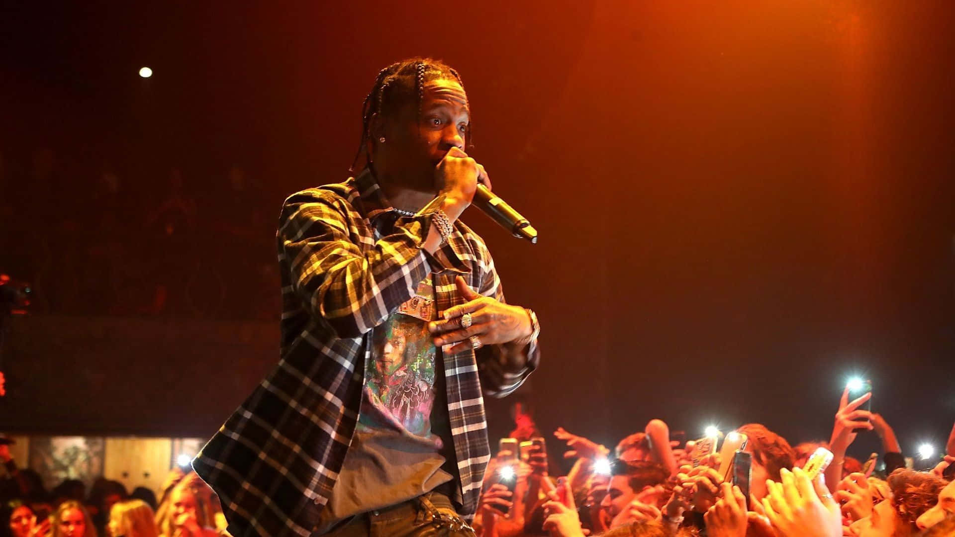 Travis Scott Electrifies The Crowd In An Explosive Show Wallpaper