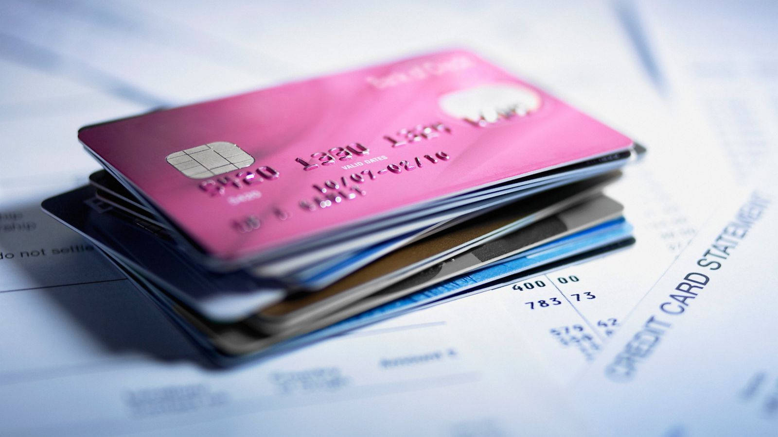 Unique Pink Credit Card Stands Out In Pile Of Credit Cards Wallpaper