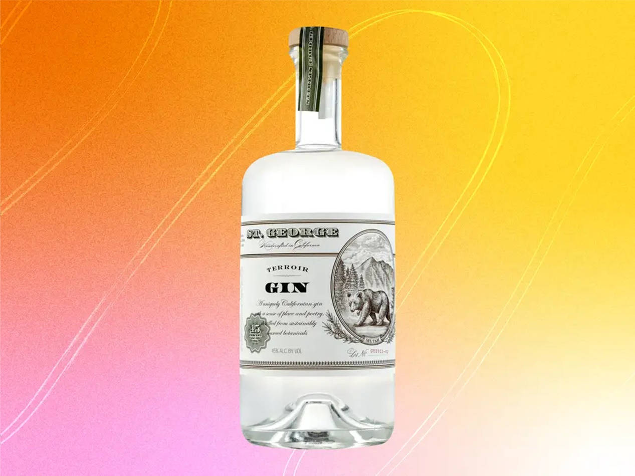 Vibrant Bottle Of St. George Terroir Gin Against An Orange Pink Background Wallpaper