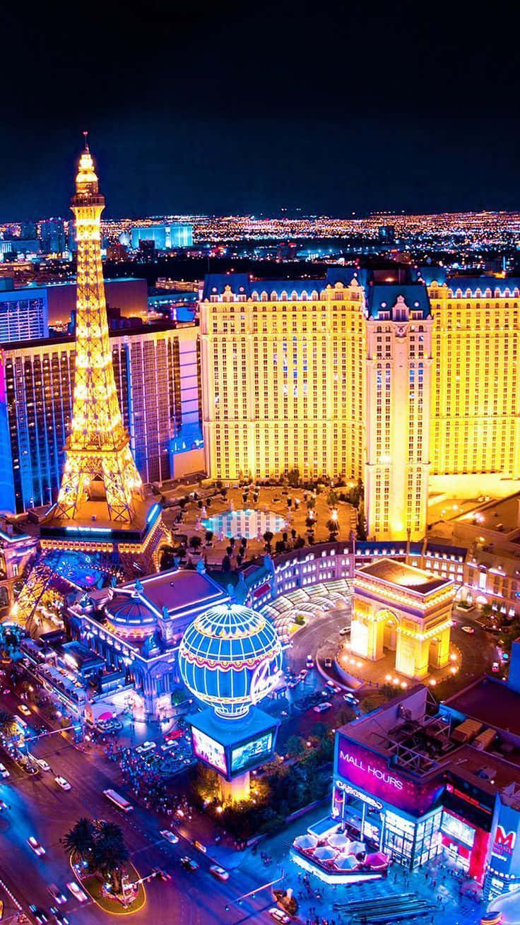Vibrant Las Vegas Cityscape At Night Through A Mobile Screen Wallpaper