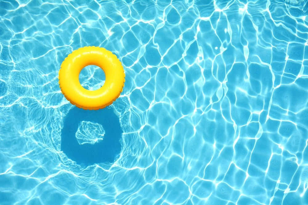 Vibrant Yellow Ring Floating On Tranquil Pool Water Wallpaper