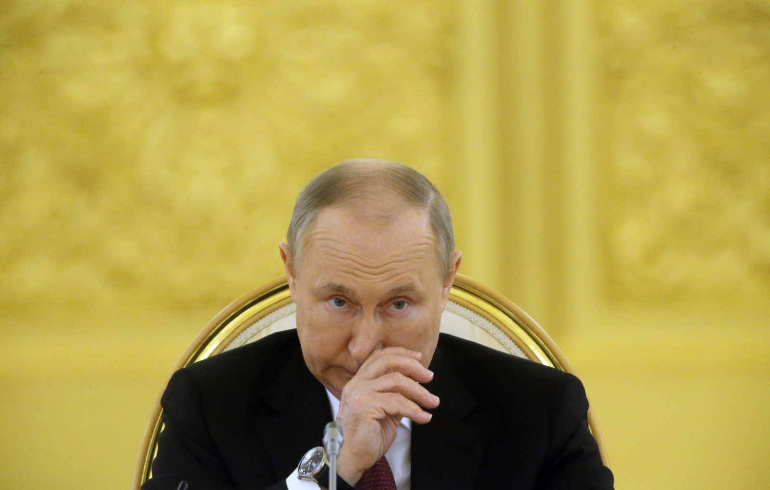 Vladimir Putin Against A Blurry Gold Background Wallpaper