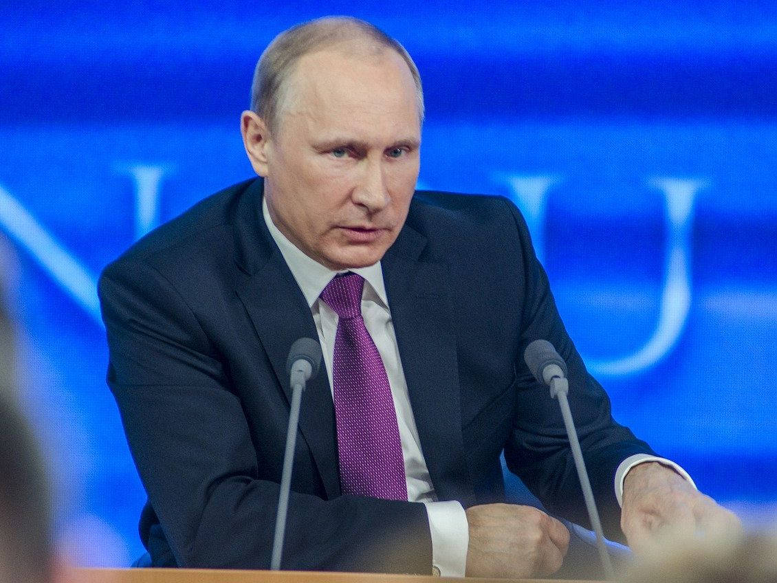 Vladimir Putin Leaning On The Podium Wallpaper