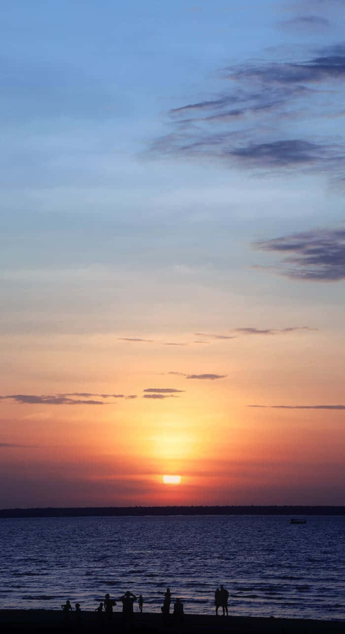 Watch The Sunset Over Picturesque Beachscape Wallpaper