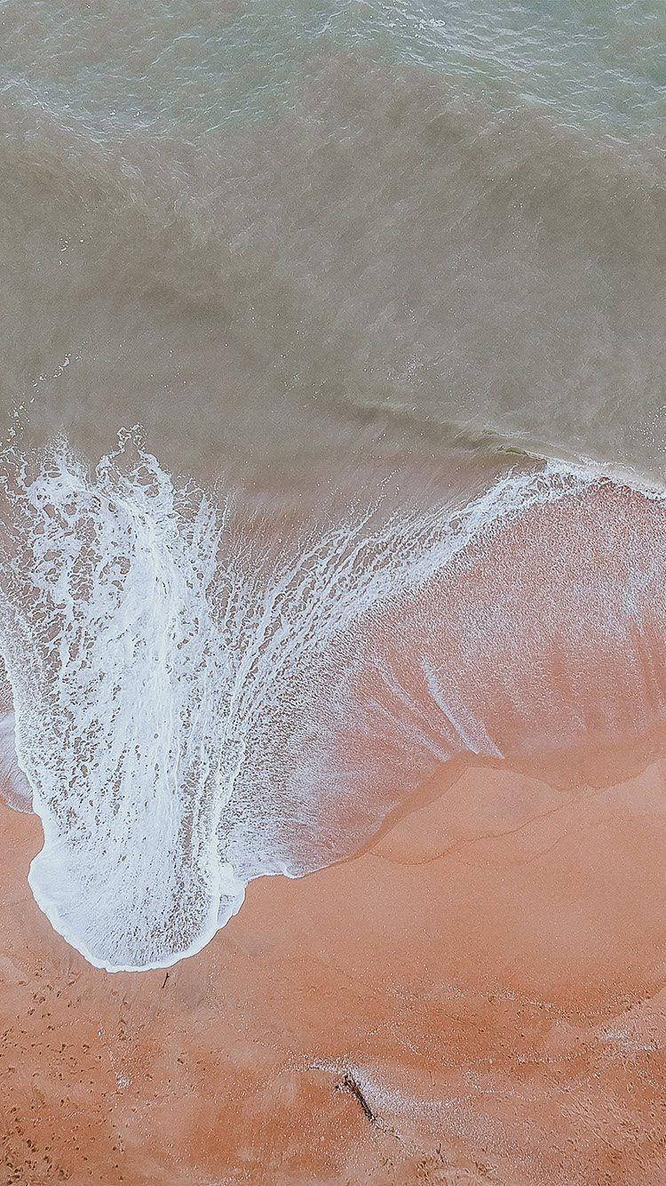 Wave Over Orange Sand Ios 12 Wallpaper