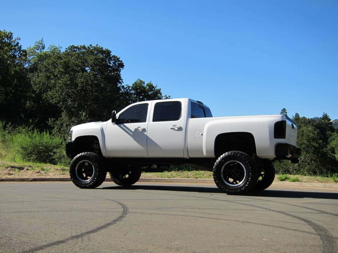 White Jacked Up Trucks Turning Left Wallpaper