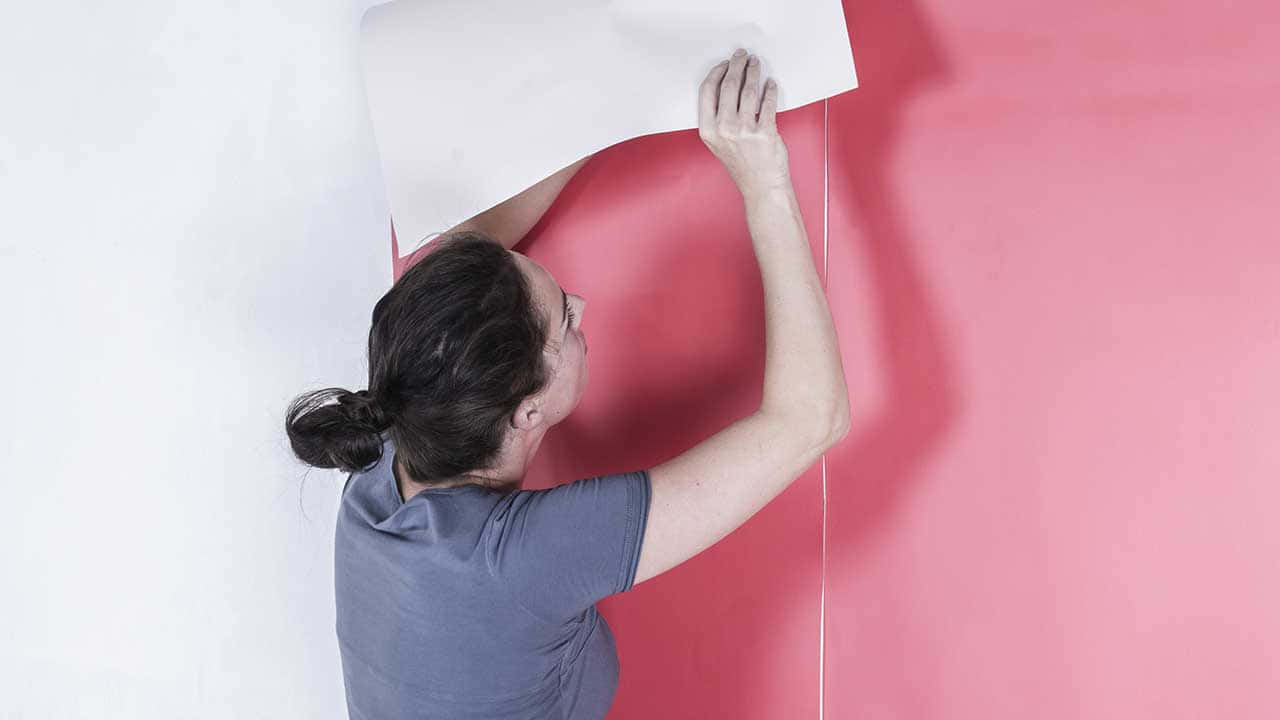 Woman Applying Posteron Wall Wallpaper