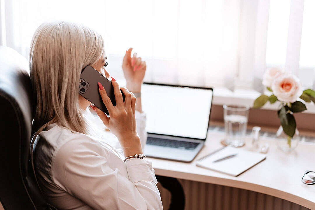 Woman Conducting Business Call At Home Office Wallpaper